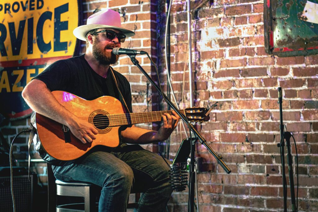 man playing guitar while singing